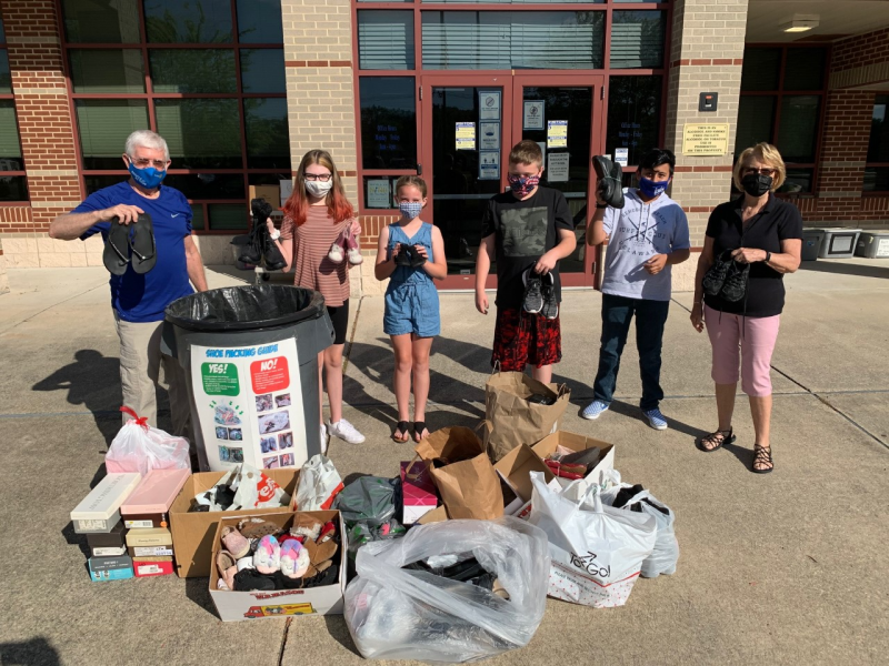 Displaying donated shoes for the Long Neck Elementary playground fundraiser are (l-r) Mike Hall, Long Neck Sunrise Rotary Club and Grace United Methodist Church; Jade Coulter; Ava Barnette; Thomas Hoopes; Liam Archila-Palomino; and Judy Hall, Long Neck Sunrise Rotary and Grace United Methodist Church. SUBMITTED PHOTO